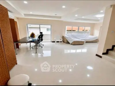Spacious modern living room with large windows and sleek furniture