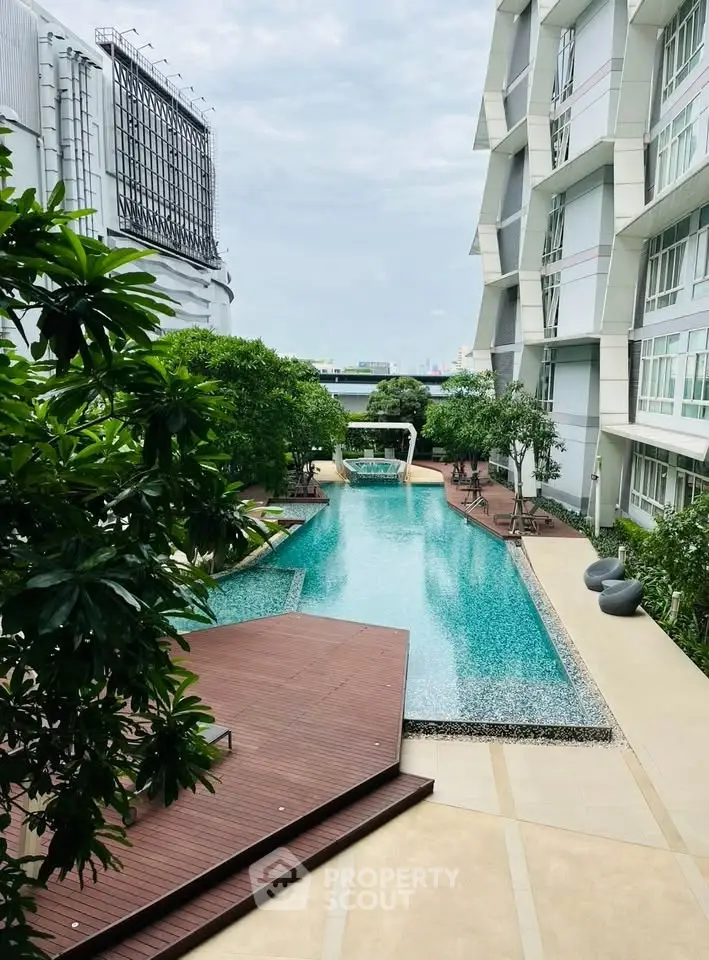 Luxurious modern apartment complex with stunning pool and lush greenery