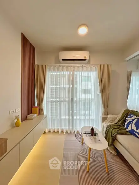 Modern living room with stylish decor and natural light, featuring a cozy sofa and elegant curtains.