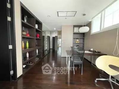 Modern study room with sleek wooden flooring and built-in shelves