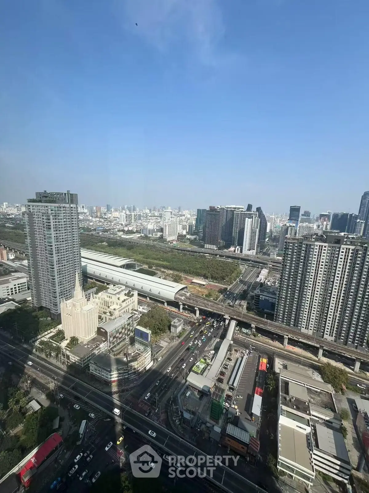 Stunning cityscape view from high-rise building showcasing urban skyline and transportation network.