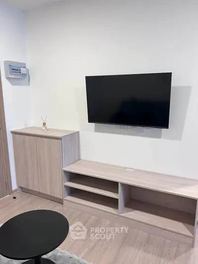 Modern living room with sleek TV setup and stylish wooden furniture