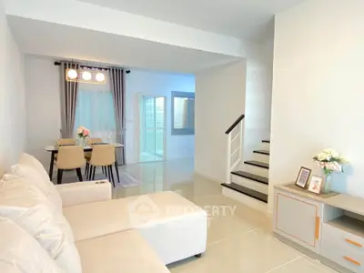 Modern living room with elegant dining area and staircase in a stylish home