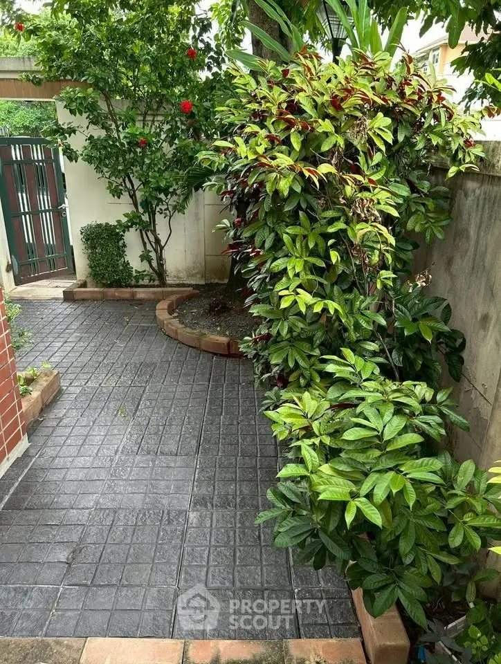 Charming garden pathway with lush greenery and brick accents