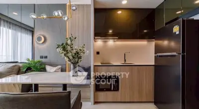 Modern open-layout kitchen with sleek appliances and stylish lighting in a contemporary apartment.