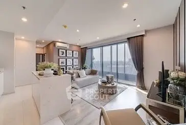 Luxurious modern living room with panoramic balcony view and elegant decor.