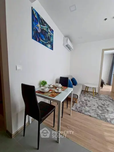 Modern living room with dining area and stylish decor in a cozy apartment.