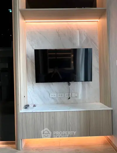Modern living room with sleek TV setup and ambient lighting