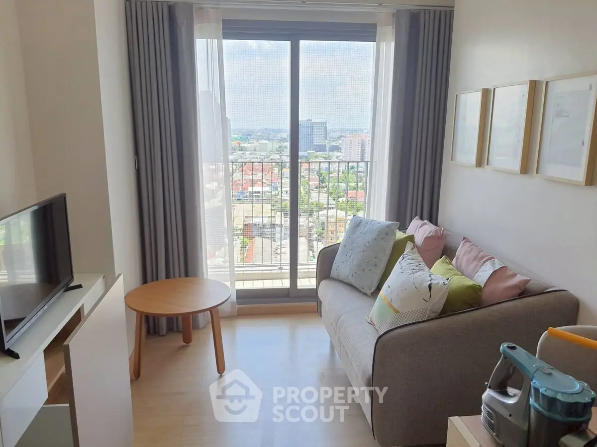 Cozy living room with a stunning city view from the balcony, featuring modern decor and ample natural light.