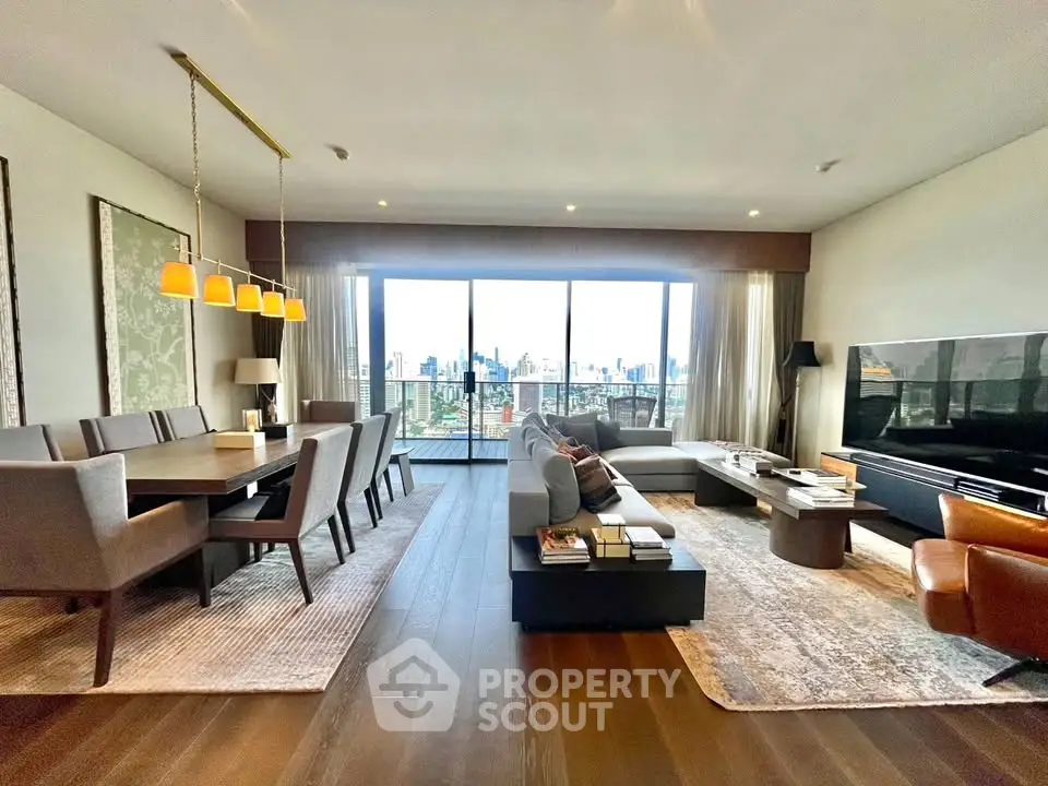 Luxurious open-plan living and dining area with stunning city view and elegant furnishings.