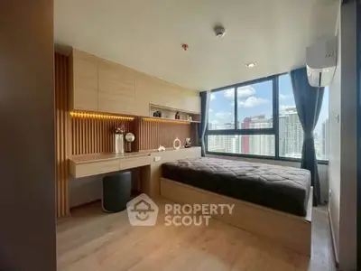 Modern bedroom with large window offering stunning city views and stylish wooden decor.
