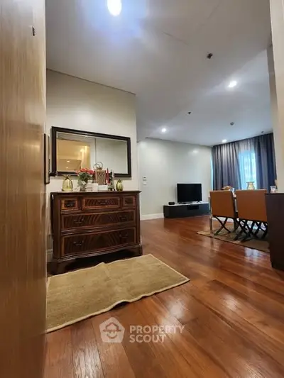 Spacious living room with elegant wooden flooring and modern decor