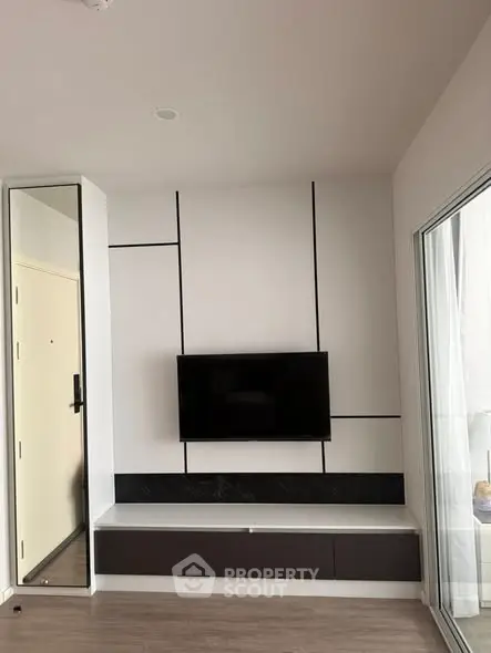 Modern living room with sleek TV setup and stylish wall design