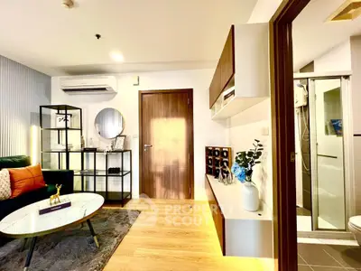 Modern living room with stylish decor and adjacent bathroom