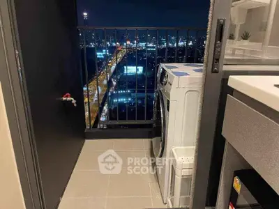 Chic urban balcony with city view and modern washing machine setup.