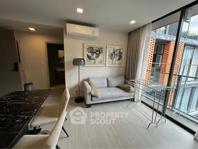 Modern living room with large windows and stylish decor in urban apartment