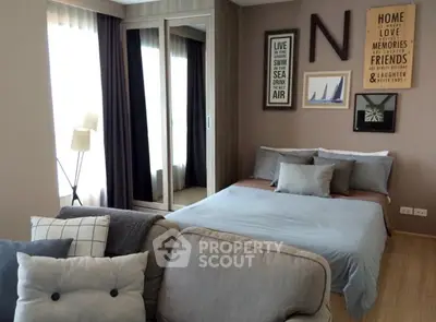 Cozy bedroom with stylish decor and ample natural light