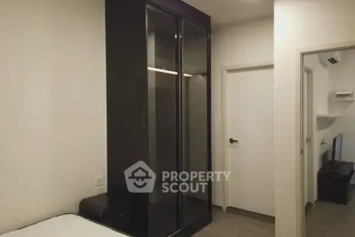 Modern bedroom with sleek black wardrobe and minimalist decor
