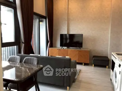 Modern living room with sleek furniture and large windows for natural light.