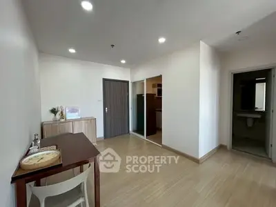 Spacious modern living area with wooden flooring and minimalist decor