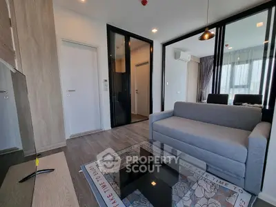Modern living room with sleek design and cozy gray sofa in a stylish apartment.