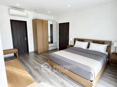 Spacious modern bedroom with wooden furniture and sleek design