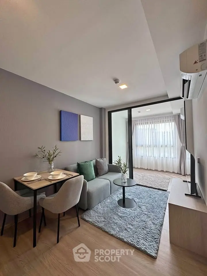 Modern living room with cozy dining area and large window view