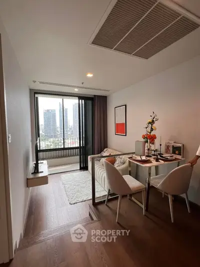 Modern living room with city view, stylish dining area, and cozy decor.