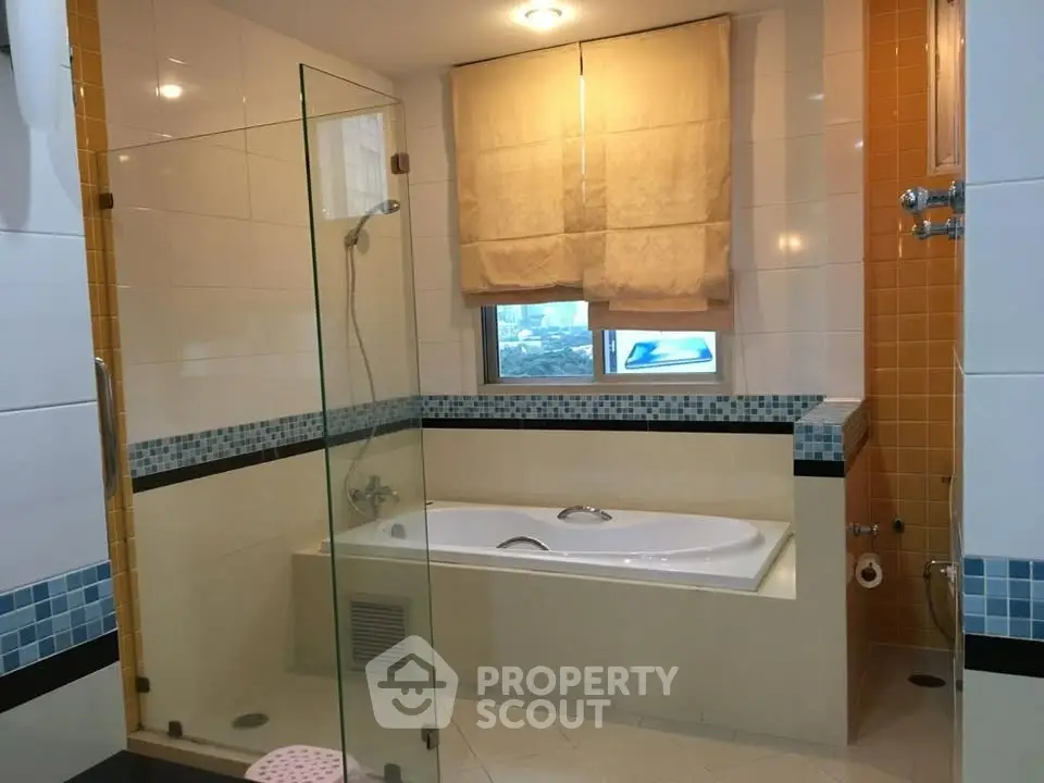 Spacious bathroom with modern bathtub and glass shower enclosure