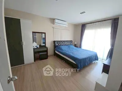 Spacious bedroom with modern furnishings and natural light