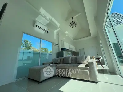 Spacious modern living room with high ceilings and large windows