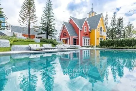 Charming colorful house with pool and lush greenery, perfect for serene living.