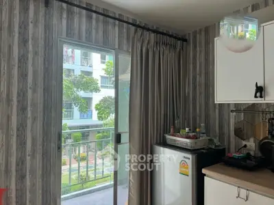 Cozy kitchen with balcony view in modern apartment