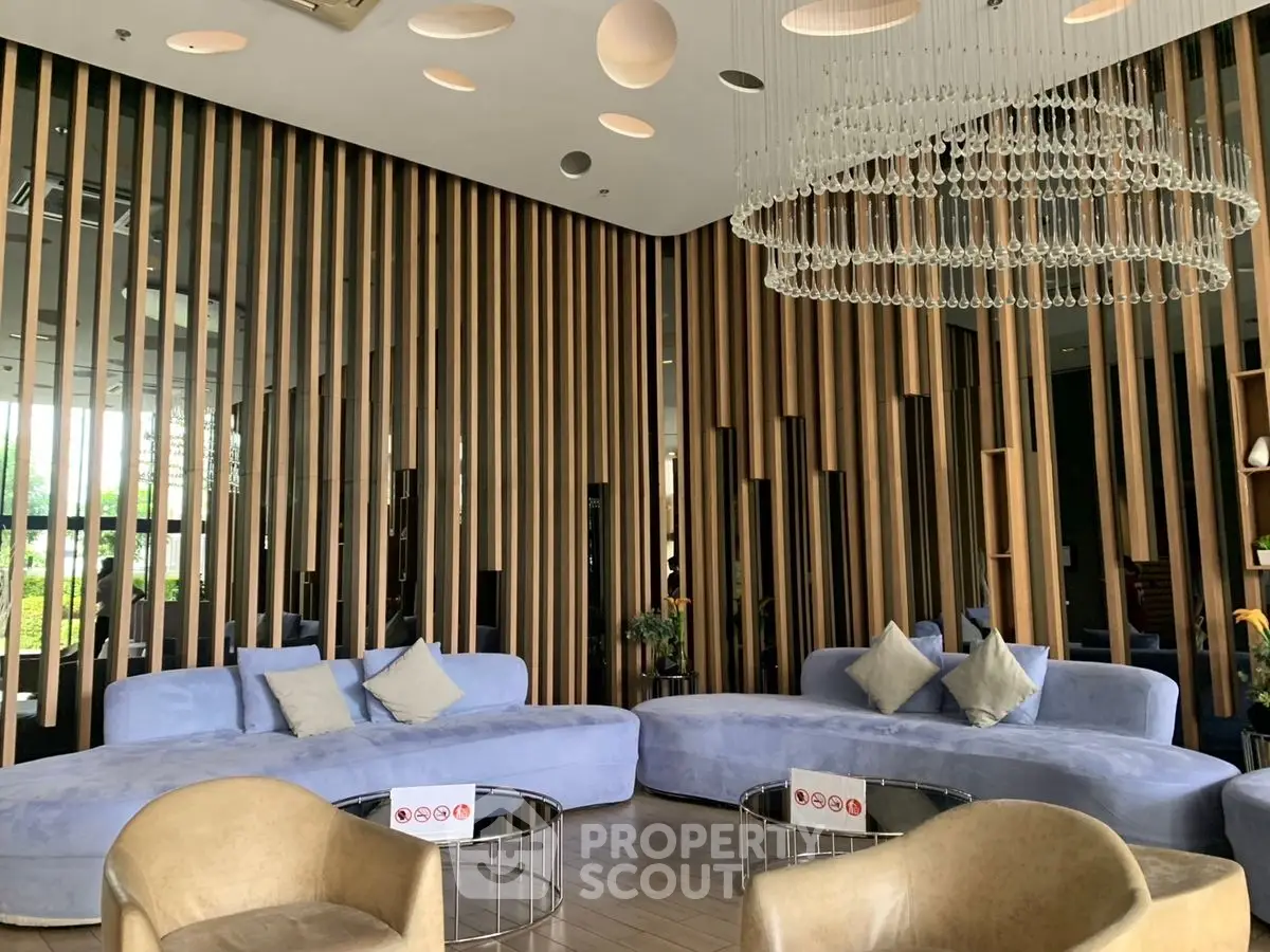 Luxurious modern living room with elegant chandelier and stylish seating area