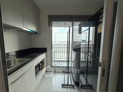 Modern kitchen with balcony view and sleek appliances