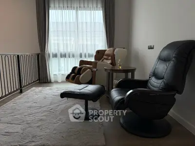 Cozy living space with massage chair and plush rug, perfect for relaxation.