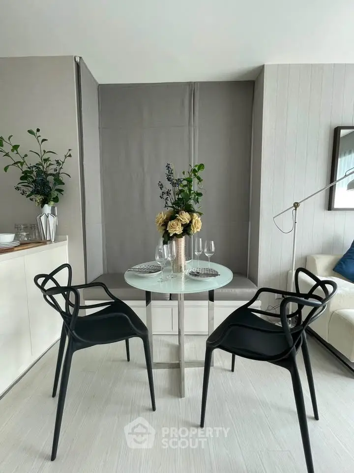 Modern dining area with stylish chairs and elegant table setting in a contemporary apartment.
