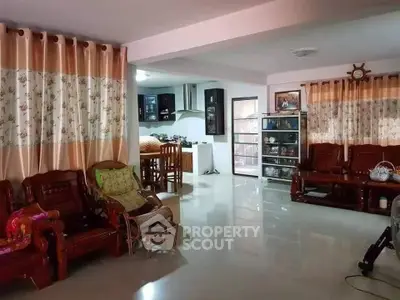 Spacious living room with elegant wooden furniture and open kitchen layout