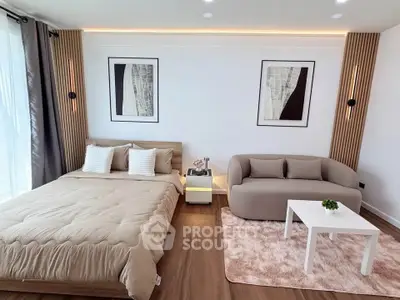 Modern bedroom with stylish decor and cozy seating area, perfect for relaxation.
