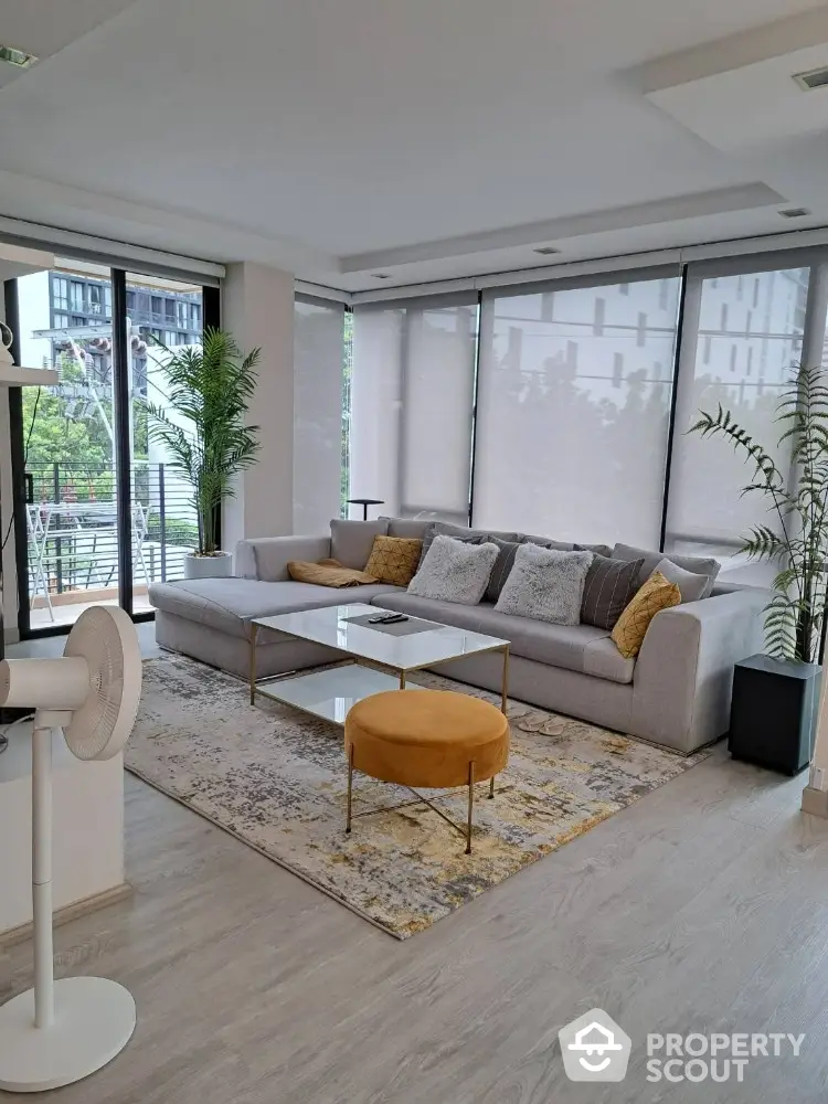 Modern living room with large windows and stylish decor in a luxury apartment