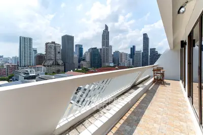 Spacious balcony with stunning city skyline view, perfect for relaxation and entertaining.