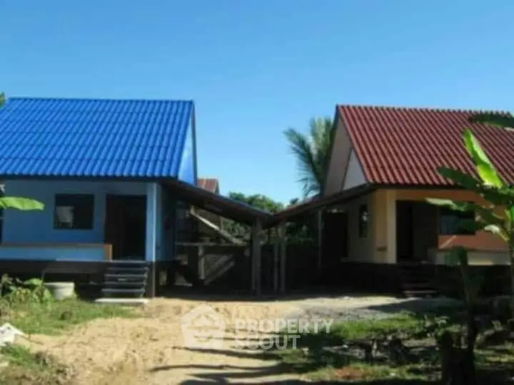 Charming twin houses with colorful roofs and lush surroundings