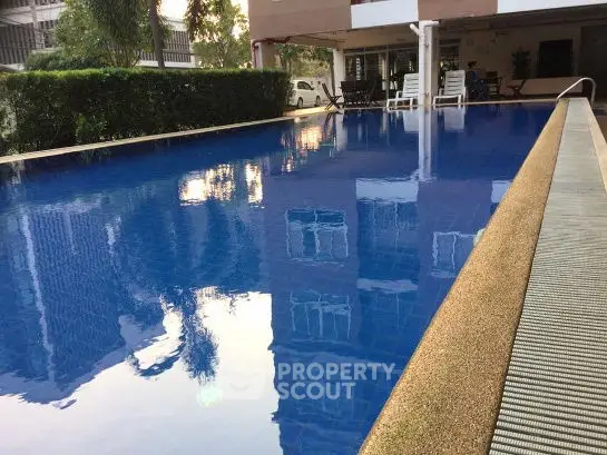 Luxurious residential pool with serene ambiance and lush greenery