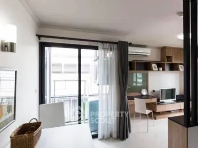 Modern living room with balcony access and stylish furniture