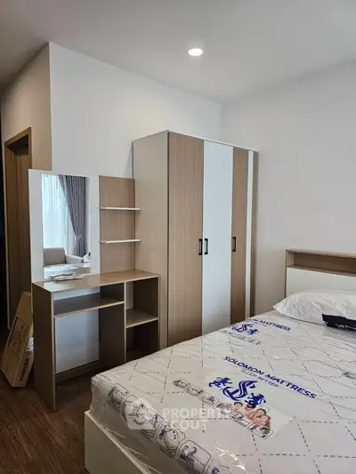 Modern bedroom with stylish wardrobe and cozy bed in a contemporary apartment.