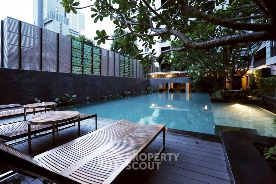 Luxurious outdoor pool area with modern design and lush greenery