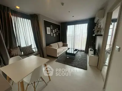 Modern living room with stylish decor and natural light in a cozy apartment.