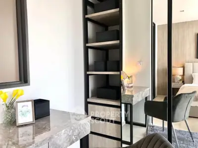 Modern bedroom with elegant decor and stylish furniture, featuring a sleek marble desk and cozy seating area.