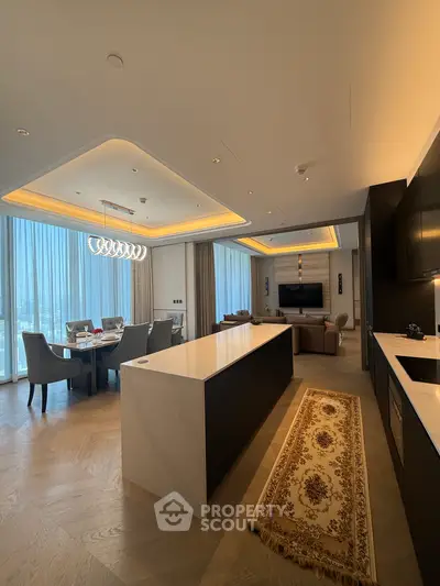 Luxurious open-plan living room with modern kitchen and elegant dining area, featuring floor-to-ceiling windows.