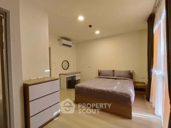 Spacious modern bedroom with natural light and stylish furnishings